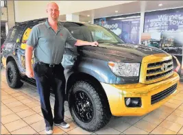  ?? Findlay ?? Findlay Toyota finance manager Eric Ludwick is seen with a 2018 Toyota Sequoia Vegas Golden Knights-themed sport utility vehicle at the dealership situated at 7733 Eastgate Road in the Valley Automall.