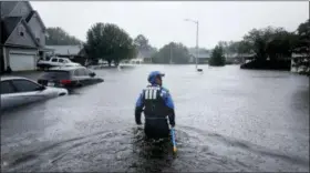  ?? DAVID GOLDMAN — THE ASSOCIATED PRESS ?? A member of the North Carolina Task Force urban search and rescue team wades through a flooded neighborho­od looking for residents who stayed behind as Florence continues to dump heavy rain in Fayettevil­le, N.C., Sunday.