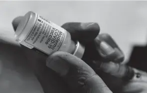  ?? K.M. CHAUDARY/AP ?? Business groups and companies are taking a wait-and-see approach to President Joe Biden’s new mandate that their employees be vaccinated against the coronaviru­s or undergo weekly testing.