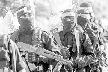  ??  ?? File photo shows fighters from the Ezzedine al-Qassam Brigades, the armed wing of the Palestinia­n Hamas movement, marching in the streets in the southern Gaza Strip city of Khan Yunis. — AFP photo
