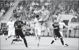  ?? Marcio Jose Sanchez Associated Press ?? LAFC goalkeeper Tyler Miller, center right, was head and shoulders above the rest Wednesday night as he clears the ball over teammate Diego Rossi, center left.