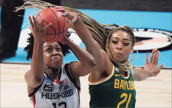  ?? Morry Gash / Associated Press ?? Baylor’s DiJonai Carrington blocks a shot by UConn’s Christyn Williams during the first half of a game in the Elite Eight round of the Women’s NCAA tournament on Monday at the Alamodome in San Antonio.