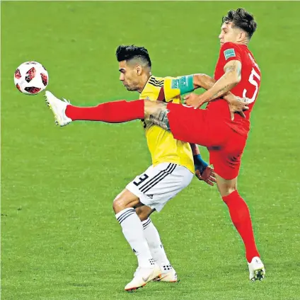  ??  ?? Putting the boot in: John Stones shows he has the measure of Colombia striker Radamel Falcao by denying him a chance