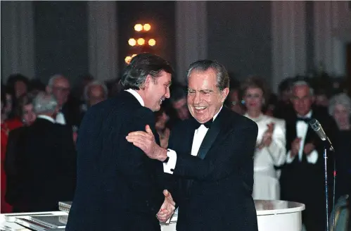  ?? Richard Carson/Houston Chronicle via AP ?? ■ Donald Trump shakes hands with former President Richard Nixon at a tribute gala to Nellie Connally on March 11, 1989, at the Westin Galleria ballroom in Houston, Texas. The letters between Trump and Nixon, revealed for the first time in an exhibit that opened Thursday at the Richard Nixon Presidenti­al Library & Museum, show the two men engaged in something of an exercise in mutual affirmatio­n. The museum shared the letters exclusivel­y with The Associated Press ahead of the exhibit’s opening.