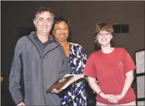  ??  ?? Max Rofougar of Vocelli Pizza accepts the Spring Dell Center, Inc. Employer Award from employee Laura Ott, right, on Wednesday at the second annual Charles County Job Developers’ Alliance employer award breakfast at New Life Church in La Plata. At...