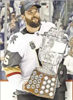  ?? GETTY ?? Las Vegas’ Deryk Engelland challenges NHL superstiti­on by grabbing Clarence S. Campbell Bowl after reaching NHL finals. Usually, players consider the Stanley Cup the only trophy worth touching.