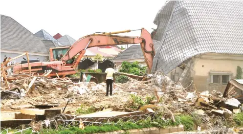 ?? Photo: Ikechuwku Ibe ?? A resident looks as a three-bedroom bungalow was pulled down by FCTA officials in EFAB Estate Lokogoma yesterday
