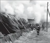  ?? RUSSIAN EMERGENCIE­S MINISTRY VIA SPUTNIK ?? Firefighte­rs put out flames at a shoe factory in Chernorech­ensky village, Novosibirs­k, Russia, on Thursday.