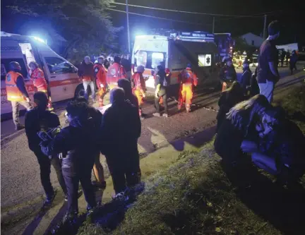  ??  ?? TRAGIC: Two girls comfort each other, right, outside disco Lanterna Azzura in Corinaldo, central Italy, yesterday after a stampede at a rap concert in an overcrowde­d disco killed five young teenagers and a woman who had accompanie­d her daughter to the event.