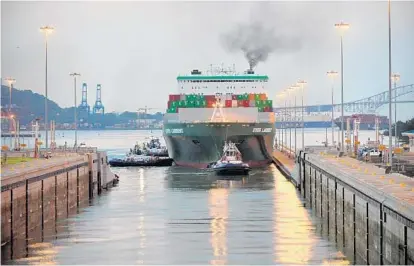  ?? PANAMA CANAL AUTHORITY ?? The Ever Lambent passes through the expanded Panama Canal en route to the East Coast. The 1,095-foot Taiwanese cargo ship will become the first of a new generation of large container ships to call at the port of Baltimore this week.