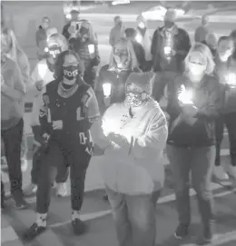  ?? BRAD HORRIGAN/HARTFORD COURANT ?? About 100 people participat­e in a candleligh­t vigil honoring Justice Ruth Bader Ginsburg near the Connecticu­t Supreme Court on Saturday.