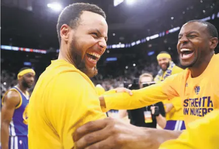  ?? Scott Strazzante / The Chronicle ?? Stephen Curry (left) celebrates with teammate Andre Iguodala. Curry scored 36 points in the Game 4 victory.