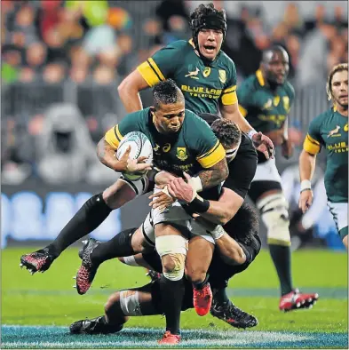  ?? Picture: GETTY IMAGES ?? FLAKY: Elton Jantjies has Warren Whiteley in support as he is tackled by two All Blacks in Christchur­ch on Saturday. Jantjies — described as flaky as a croissant by a Kiwi journalist — is under pressure to keep his place in the team.