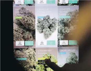  ??  ?? Shoppers at San Francisco’s Medithrive browse cannabis types on an electronic display. Industry observers are concerned pot producers’ financial statements could be inaccurate due to the use of a fair-value model used by the agricultur­al industry that...