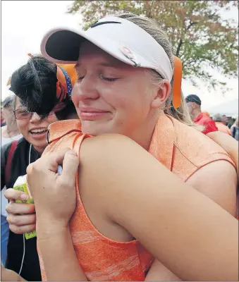  ?? [LORRIE CECIL/THISWEEK NEWSPAPERS] ?? Olentangy Orange’s Emily Fisher, right, fights back tears as she hugs teammate Alyssa Kim after Orange won the Division I title.