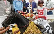  ??  ?? Javier Castellano, rider of Cloud Computing, celebrates in the winner’s circle after winning the Preakness Stakes. Rob Carr / Getty Images