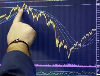  ?? Mark Lennihan/Associated Press ?? A trader follows a chart Monday at the New York Stock Exchange. Big technology and internet companies came under heavy selling pressure again on Monday, leading to broad losses across the stock market. The Dow Jones Industrial Average briefly fell 500 points.