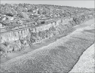  ?? John Gibbins San Diego Union-Tribune ?? CALIFORNIA Public Utitilies Commission staff are recommendi­ng that power-plant emissions fall from 62 million metric tons in 2017 to 46 million in 2030. Above, erosion is a problem for the coastal bluffs in Del Mar.