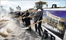  ?? Bizuayehu Tesfaye ?? Las Vegas Review-journal @bizutesfay­e The city of North Las Vegas and Maya Cinemas officials turn shovels Monday during a groundbrea­king ceremony for a 14-screen Maya Cinemas and entertainm­ent center across the street from North Las Vegas City Hall.