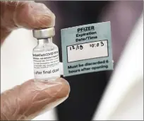  ?? AP photo ?? A vial of the Pfizer vaccine used at The Reservoir nursing facility is shown Dec. 18 in West Hartford, Conn. While a University of Hawaii survey of more than 600 residents last month showed that only 44 percent plan to get the vaccine once it’s available, some health care providers and frontline workers on Maui are looking forward to being the first in line.