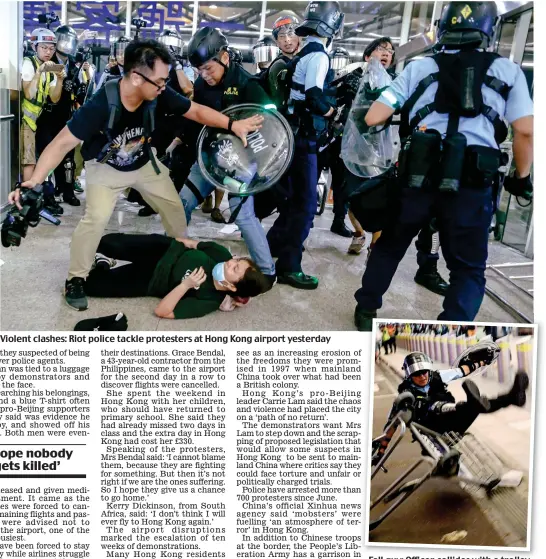  ??  ?? Violent clashes: Riot police tackle protesters at Hong Kong airport yesterday Fall guy: Officer collides with a trolley
