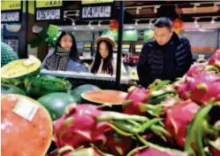  ??  ?? February 10, 2019: Customers buy fruit at a supermarke­t in Shijiazhua­ng, Hebei Province. During the 2019 Spring Festival holiday, household consumptio­n in China exceeded one trillion yuan (US$ 125 billion), up 8.5 percent year- on-year. VCG