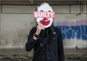  ?? REUTERS ?? Malaysian artist and activist Fahmi Reza poses for a picture holding his artwork bearing an image of former Prime Minister Najib Razak, in Kuala Lumpur, Malaysia on Wednesday.