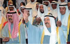  ??  ?? His Highness the Amir Sheikh Sabah Al-Ahmad Al-Jaber Al-Sabah waves as His Highness the Crown Prince Sheikh Nawaf Al-Ahmad Al-Jaber Al-Sabah is seen.