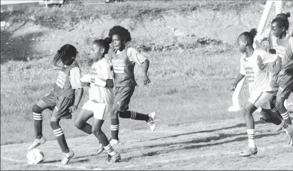  ??  ?? Action between Enterprise (in blue) and Tucville in the Smalta Girls Pee Wee Football Championsh­ip.