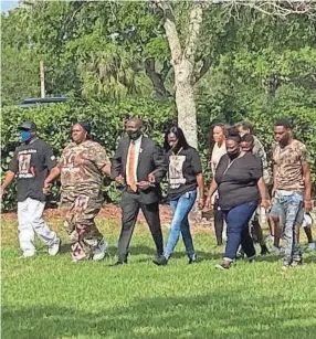  ?? TYLER VAZQUEZ ?? Ben Crump walks arm in arm with Sincere Pierce’s family outside the Moore Justice Center in Viera