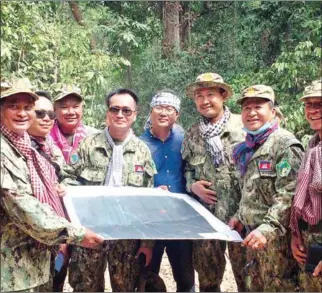  ?? SUPPLIED ?? Wildlife rangers show a map of the area where the Ministry of Environmen­t plans to establish a patrol station near the junction between three provinces in Prey Lang Wildlife Sanctuary.