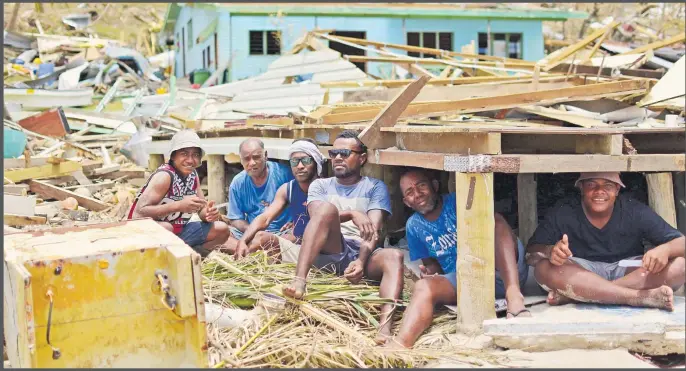  ?? Picture: JOVESA NAISUA ?? SURVIVORS … Kia Island villagers did whatever they could to stay alive. Desperate villagers fled under the floors of their homes, while others such as Josefa Rokogata and his uncle jammed themselves into a cabinet.