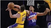  ?? MARK J. TERRILL – THE ASSOCIATED PRESS ?? Lakers guard Austin Reaves, left, shoots as Suns forward Darius Bazley defends during the first half Wednesday night.