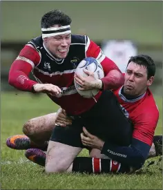  ??  ?? Wicklow’s Ben Armstrong is tackled by Mullingar’s Jamie Taffe.