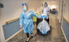  ??  ?? CVS pharmacy intern Abigail White and pharmacist Susan Kontrik, of Brighton Heights, walk to residents’ rooms to administer doses of the Pfizer COVID-19 vaccine on Jan. 8 at Concordia at Rebecca Residence.