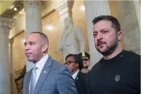  ?? Photo/Alex Brandon/File) ?? House Minority Leader Hakeem Jeffries, of N.Y., left, walks with Ukrainian President Volodymyr Zelenskyy in the U.S. Capitol to a meeting with other congressio­nal leaders on Dec. 12, 2023, in Washington. (AP