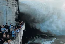  ?? Picture: REUTERS/KHAM ?? HEAVY RAINFALL: People watch as Hoa Binh hydroelect­ric power plant opens the floodgates after heavy rainfall