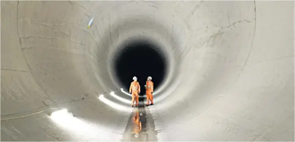  ??  ?? Ground work: Millicent and Ursula are expected to displace around four million tons of spoil in the project. Left: Canon Alexander Sherbrooke blesses the two tunnels