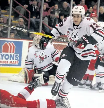  ?? BRIAN KELLY/POSTMEDIA NETWORK ?? Niagara Ice Dogs Kirill Maksimov steps over a Soo Greyhound during third-period action at Essar Centre in Sault Ste. Marie, Ont., on Saturday.