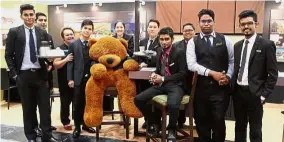  ??  ?? YTL Internatio­nal College of Hotel Management students looking dapper as they pose with their mascot - a huge teddy bear.