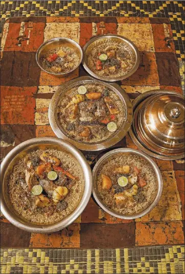  ?? (AP/Grace Ekpu) ?? Bowls of Senegal’s national dish, thieboudie­nne, are prepared for lunch May 31 in Diamniadio, Senegal.