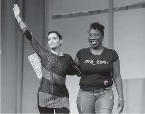  ?? AP Photo/Paul Sancya, File ?? ■ In this Oct. 27, 2017, file photo, actress Rose McGowan, left, waves after being introduced by Tarana Burke, right, founder of the #MeToo movement, at the inaugural Women’s Convention in Detroit.