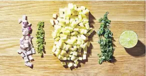  ??  ?? Pineapple, shown with red onion, jalapeno, cilantro and lime, can provide sweet and tart flavours to a salsa.