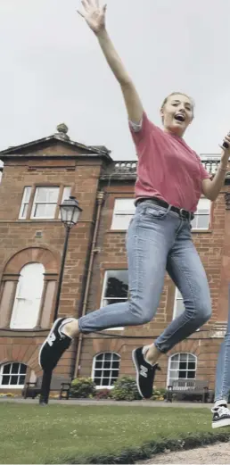  ??  ?? Students celebrate their exam results yesterday amid concerns over cuts to school budgets and teacher numbers and their impact on pupils