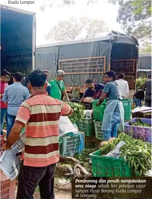  ??  ?? Pemborong dan peraih menjalanka­n urus niaga sebaik lori pekebun sayur sampai Pasar Borong Kuala Lumpur di Selayang.