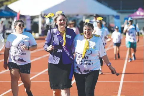  ?? Pictures: BRENDAN RADKE & ANNA ROGERS ?? POWERFUL BOND: Ovarian cancer survivor Jodie Budgen and breast cancer survivor Bonnie Martin supported last year’s Cairns Relay for Life at Barlow Park. BELOW: Relay for Life chairperso­n Christina French and Jodie Budgen.