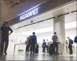  ??  ?? In this file photo, people look at a Huawei store in Shenzhen Bao’an Internatio­nal Airport in Shenzhen in southern China’s Guangdong Province. (AP)