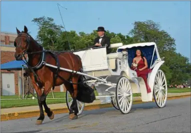  ?? PETE BANNAN – DIGITAL FIRST MEDIA ?? Mikalia Heacock and Zack Hillard came to the 2018Coates­ville Prom on a romantic horse- drawn carriage. “I’m a horseback rider and I want to arrive in style,” said Heacock.