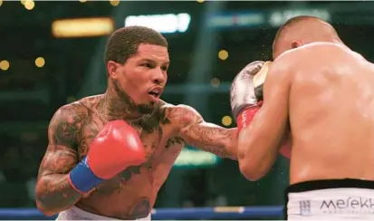  ?? DAVID SWANSON/AP ?? Gervonta Davis, left, throws a punch at Isaac Cruz during their WBC lightweigh­t title boxing bout in Los Angeles on Dec. 5, 2021. Davis will fight Rolando Romero at the Barclays Center in New York on Saturday night.