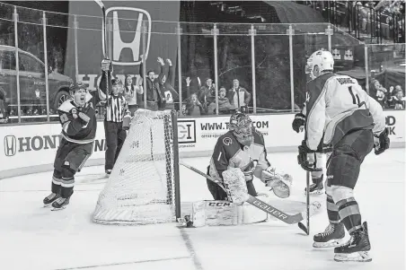  ?? Howard Simmons, The Associated Press ?? New York Islanders center Casey Cizikas celebrates after teammate Ryan Pulock scored the game-winning goal against the Avalanche in overtime Saturday in New York. The Islanders won 4-3.